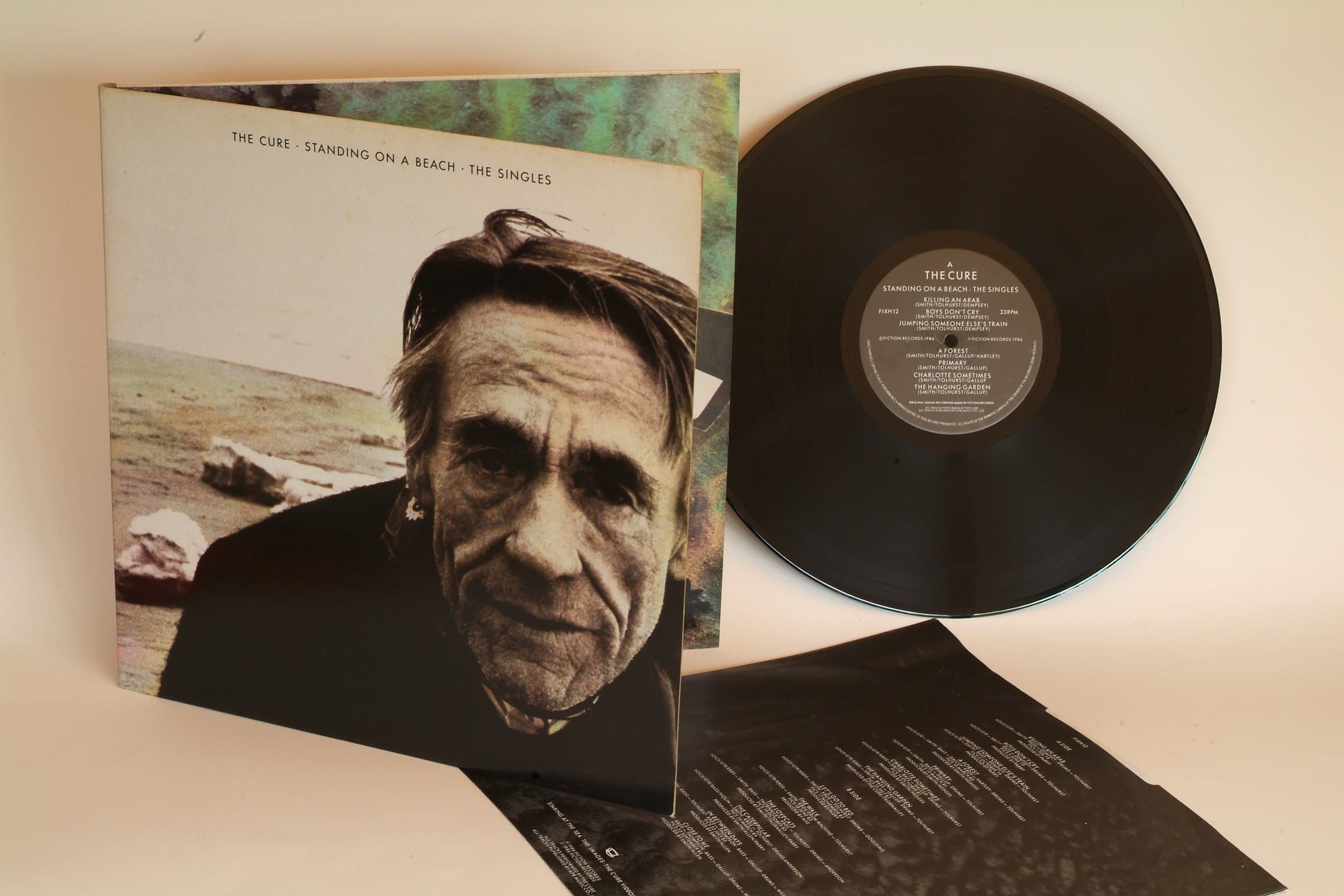 THE CURE standing on a beach the singles. First UK press, hand written matrix AND BACK AGAIN ARUN, 1986 on Fiction records.